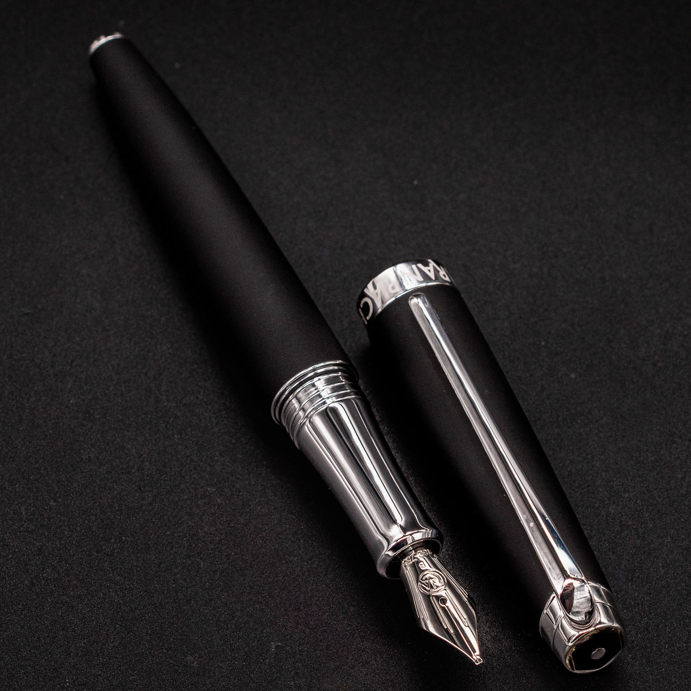 Léman V2 Matte Black pen barrel and cap resting side by side
