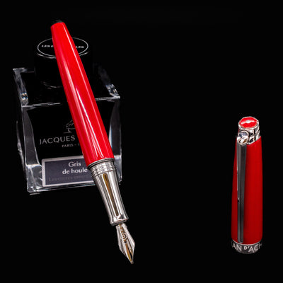 Caran d’Ache Léman V2 Scarlet pen uncapped and resting on ink bottle