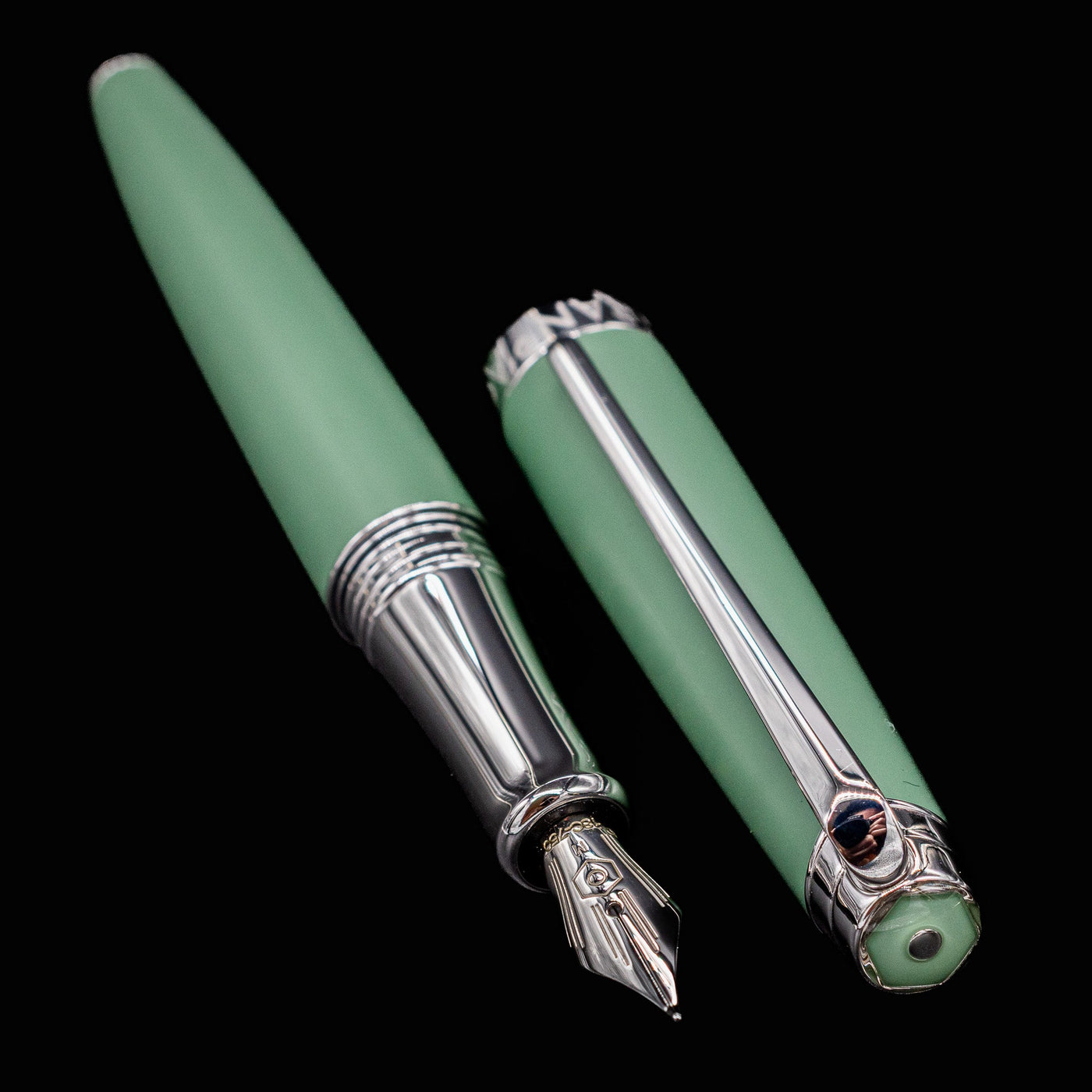Léman V2 Vert de Gris pen and cap placed side-by-side with the nib pointing forward, highlighting shape and finish.

