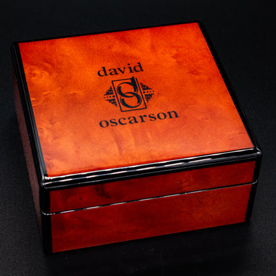 David Oscarson luxury cufflink box with logo on orange lacquered lid