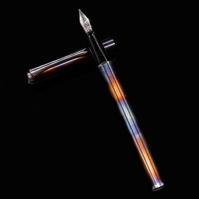 Diplomat Traveller Flame pen uncapped and resting on the cap, highlighting flame pattern