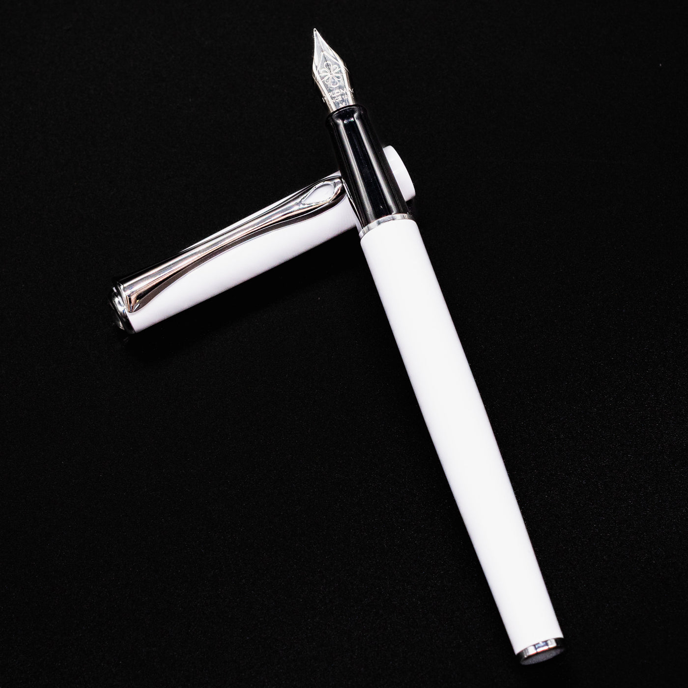 Open Diplomat Traveller Fountain Pen White & Chrome laid flat with cap beside the barrel