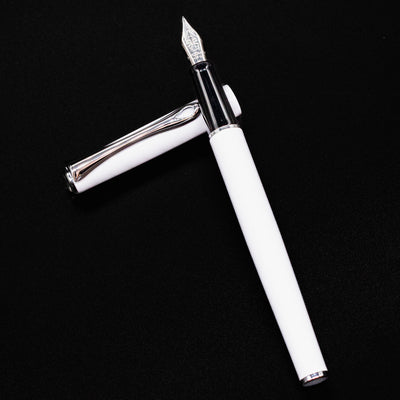 Open Diplomat Traveller Fountain Pen White & Chrome laid flat with cap beside the barrel