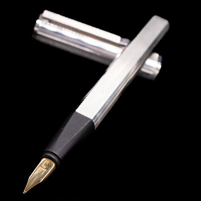 Angled view of Dunhill Gemline Sterling Silver Fountain Pen with gold nib and textured silver barrel