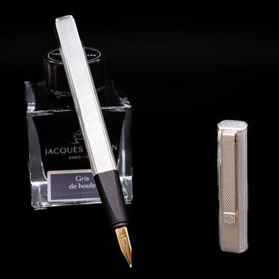 Dunhill Gemline Classic Dress Sterling Silver Fountain Pen with gold nib resting on Jacques Herbin ink bottle