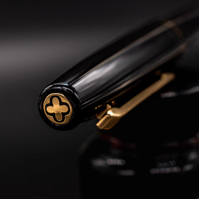 Closeup of Esterbrook Camden Black & Gold gold plated cap top finial