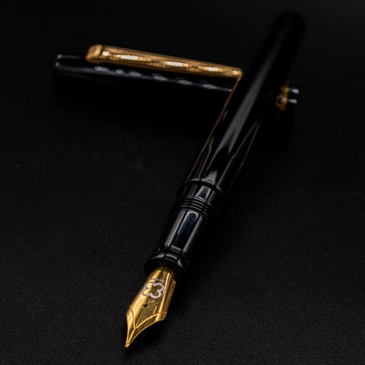 Esterbrook Camden Black & Gold pen uncapped with nib aimed toward camera - premium writing experience