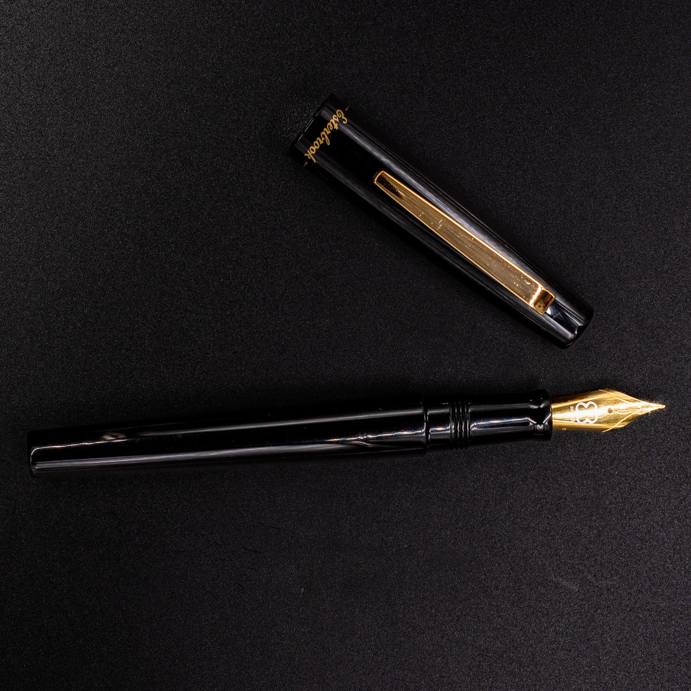 Full overhead view of Esterbrook Camden Black & Gold fountain pen uncapped - modern elegant writing pen