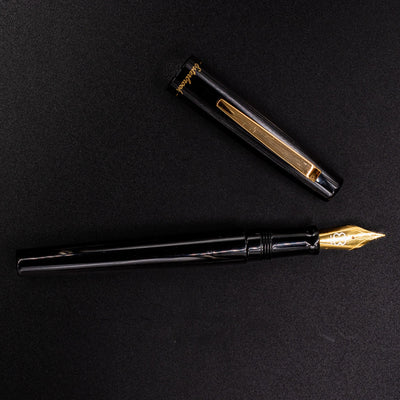 Full overhead view of Esterbrook Camden Black & Gold fountain pen uncapped - modern elegant writing pen