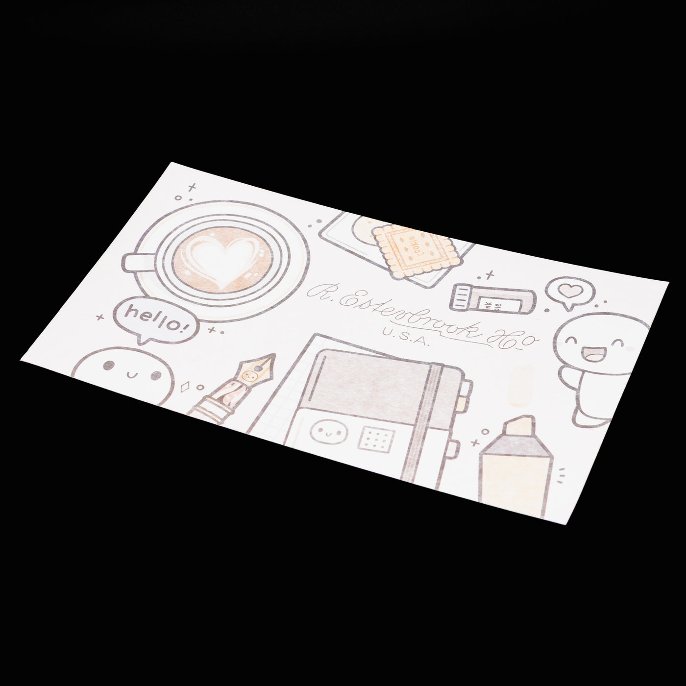 Flatlay of Esterbrook x TheCoffeeMonsterzCo "Keep Creating" blotter paper featuring cute coffee-themed illustrations and stationery items.