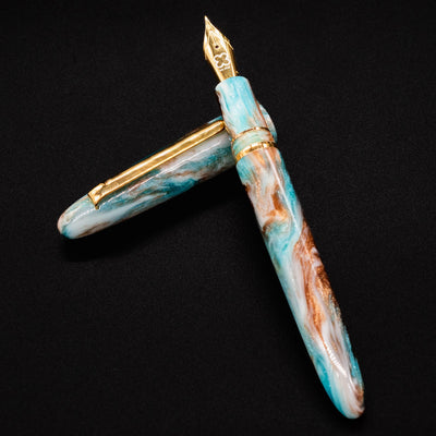 Esterbrook Estie Avalanche fountain pen body resting on cap - swirl of white frost, silver, turquoise, and copper