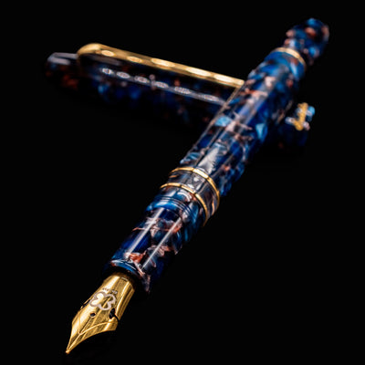 Close-up of Esterbrook Estie Nouveau Bleu fountain pen showing gold nib and marbled blue resin barrel
