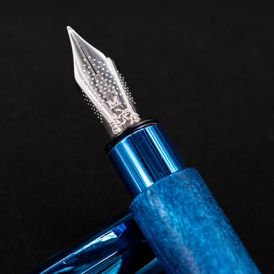 Close-up of the stainless steel nib on the Faber-Castell Ambition Fountain Pen - Blue Wood, marked with an “M”.