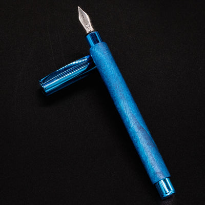 Faber-Castell Ambition Fountain Pen - Blue Wood opened and laid flat, cap resting to the side.