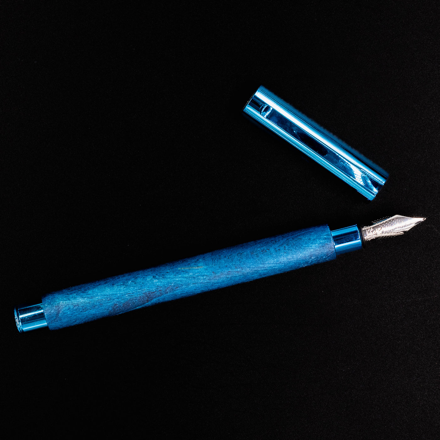Top-down view of the Faber-Castell Ambition Fountain Pen - Blue Wood laid horizontally with the cap removed.