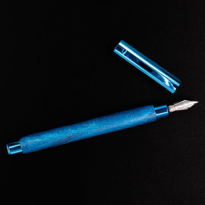 Top-down view of the Faber-Castell Ambition Fountain Pen - Blue Wood laid horizontally with the cap removed.