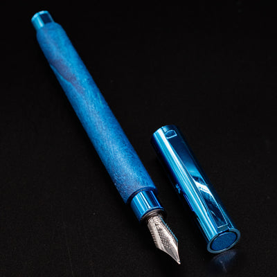 Faber-Castell Ambition Fountain Pen - Blue Wood displayed uncapped with nib exposed and cap beside it.