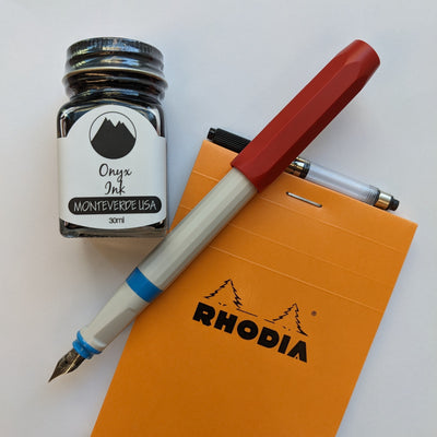 Fountain Pen with notebook and bottle of ink