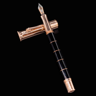 Graf von Faber-Castell Classic Anello Rose Gold fountain pen with cap off and nib upright on black background.