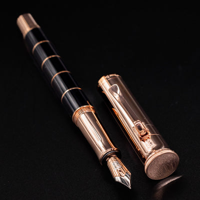 Graf von Faber-Castell Classic Anello Fountain Pen in Rose Gold shown uncapped and resting on black background.
