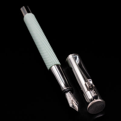 Graf von Faber-Castell Guilloche Fountain Pen in Sage Green shown open next to metal cap