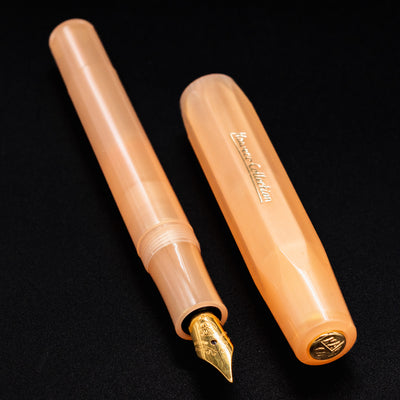 Kaweco Collector's Sport Apricot Pearl Fountain Pen with its matching cap displayed side-by-side.