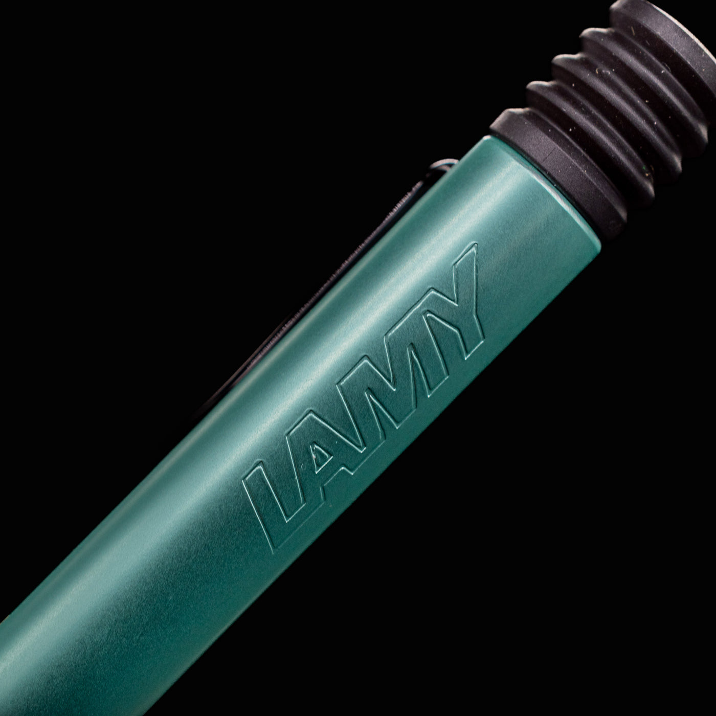 Detailed macro shot of LAMY logo etched on the barrel of the Al-Star Ballpoint Pen in Mint green.