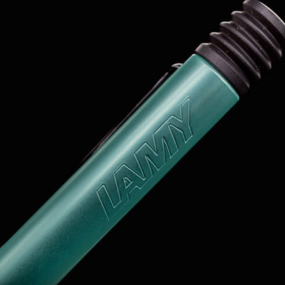 Detailed macro shot of LAMY logo etched on the barrel of the Al-Star Ballpoint Pen in Mint green.