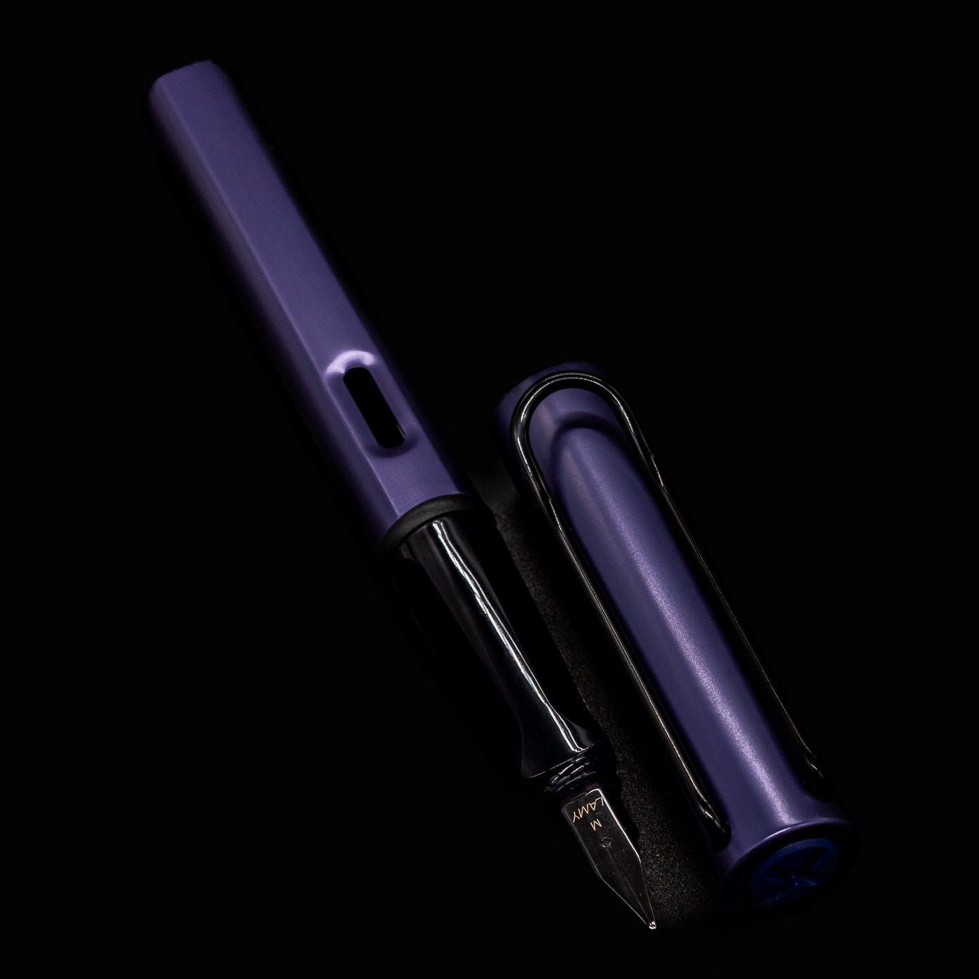 LAMY Al-Star Fountain Pen Dark Dusk with nib pointing down on a dark background