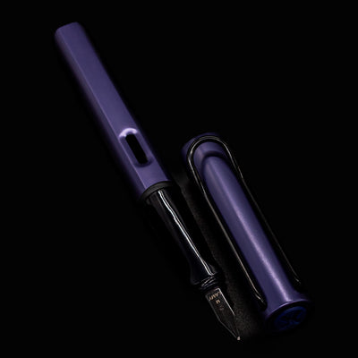 LAMY Al-Star Fountain Pen Dark Dusk with nib pointing down on a dark background