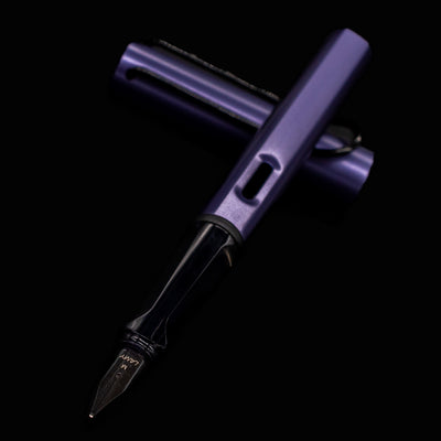 Close-up of the LAMY Al-Star Fountain Pen Dark Dusk steel nib and transparent grip section
