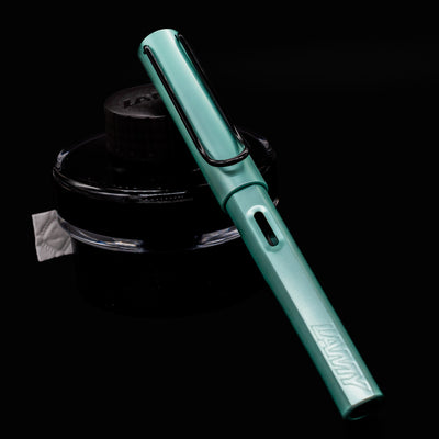 LAMY Al-Star Fountain Pen in Mint shown capped at a front angle on black background