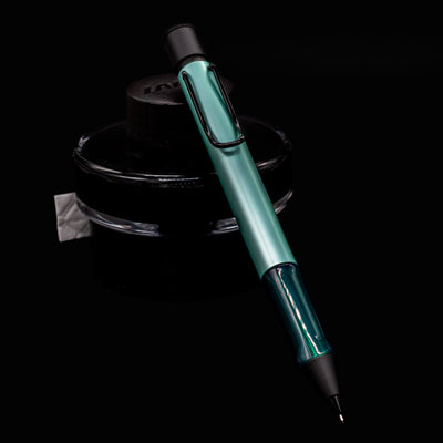 LAMY Al Star Mechanical Pen in Mint resting on black LAMY ink bottle with matte black accents