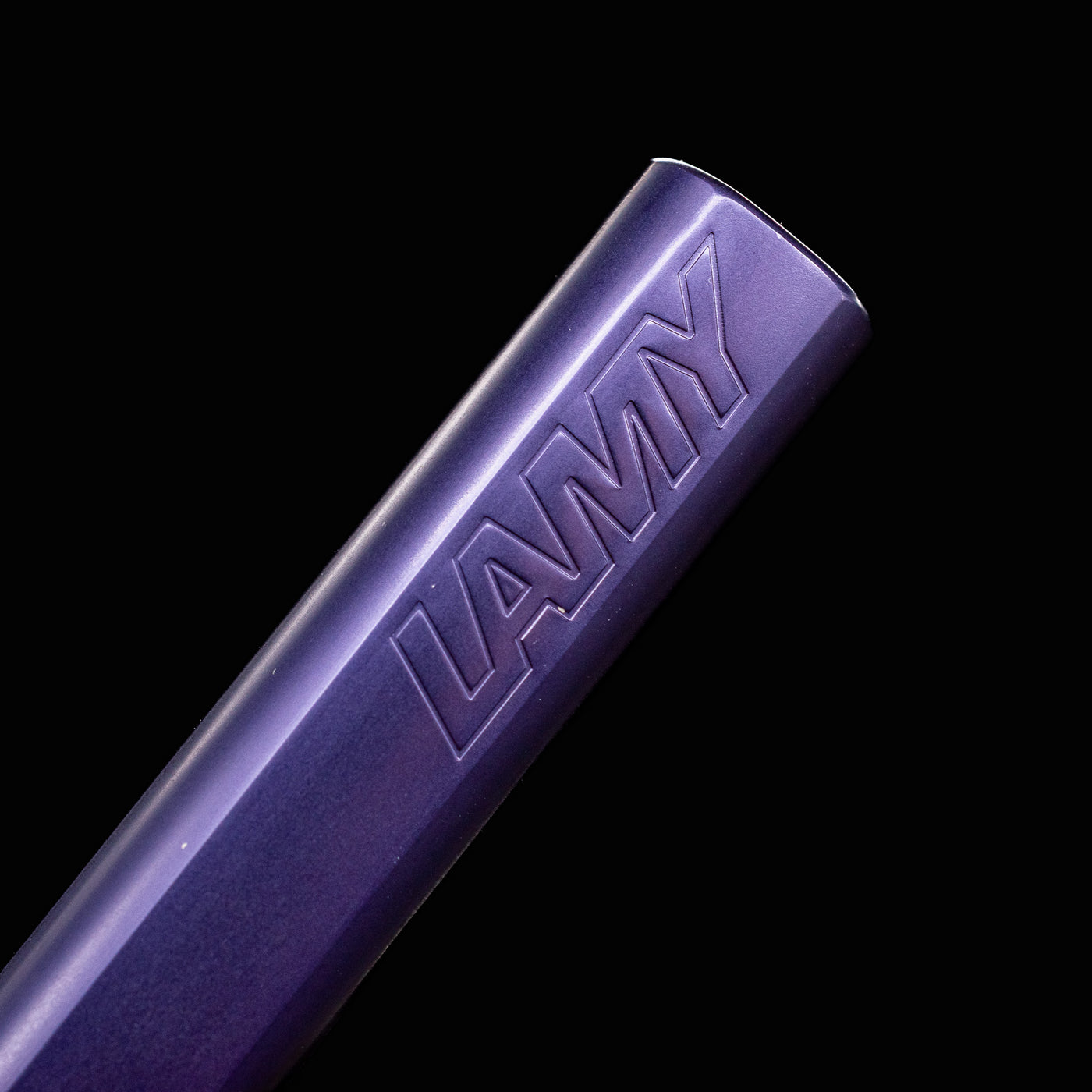 Close-up of LAMY logo embossed on the Dark Dusk Al-Star Rollerball Pen barrel