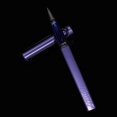 Flat lay of LAMY Al-Star Rollerball Pen in Dark Dusk color with cap removed