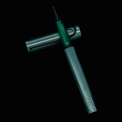 LAMY Al Star Mint Rollerball Pen with cap off and pen laying across the cap