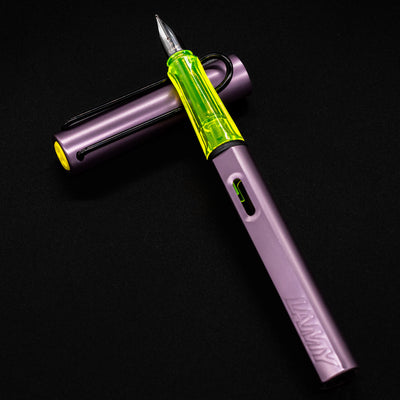 LAMY Al-Star Special Edition Aubergine Fountain Pen with cap off in a flatlay showing vibrant color contrast and pen details.