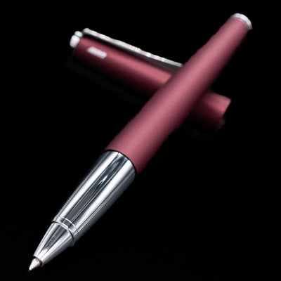 LAMY studio rollerball pen orion laying across its own cap, crossed.