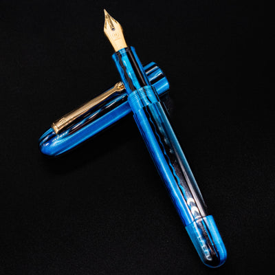 Molteni Modelo 71 Blue & Gold Fountain Pen displayed flat with nib and cap positioned diagonally.