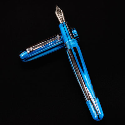 Molteni Modelo 71 Blue & Rhodium Fountain Pen uncapped and displayed flat against a black background.