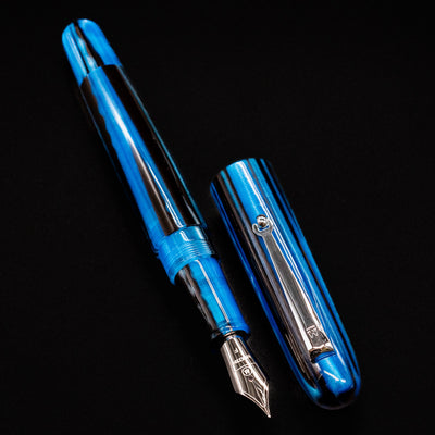 Molteni Modelo 71 Blue & Rhodium Fountain Pen and its cap placed side by side.