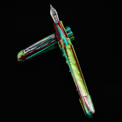 Flat lay diagonal shot of the Molteni Modelo 71 Fountain Pen in Green and Rhodium, uncapped with nib up