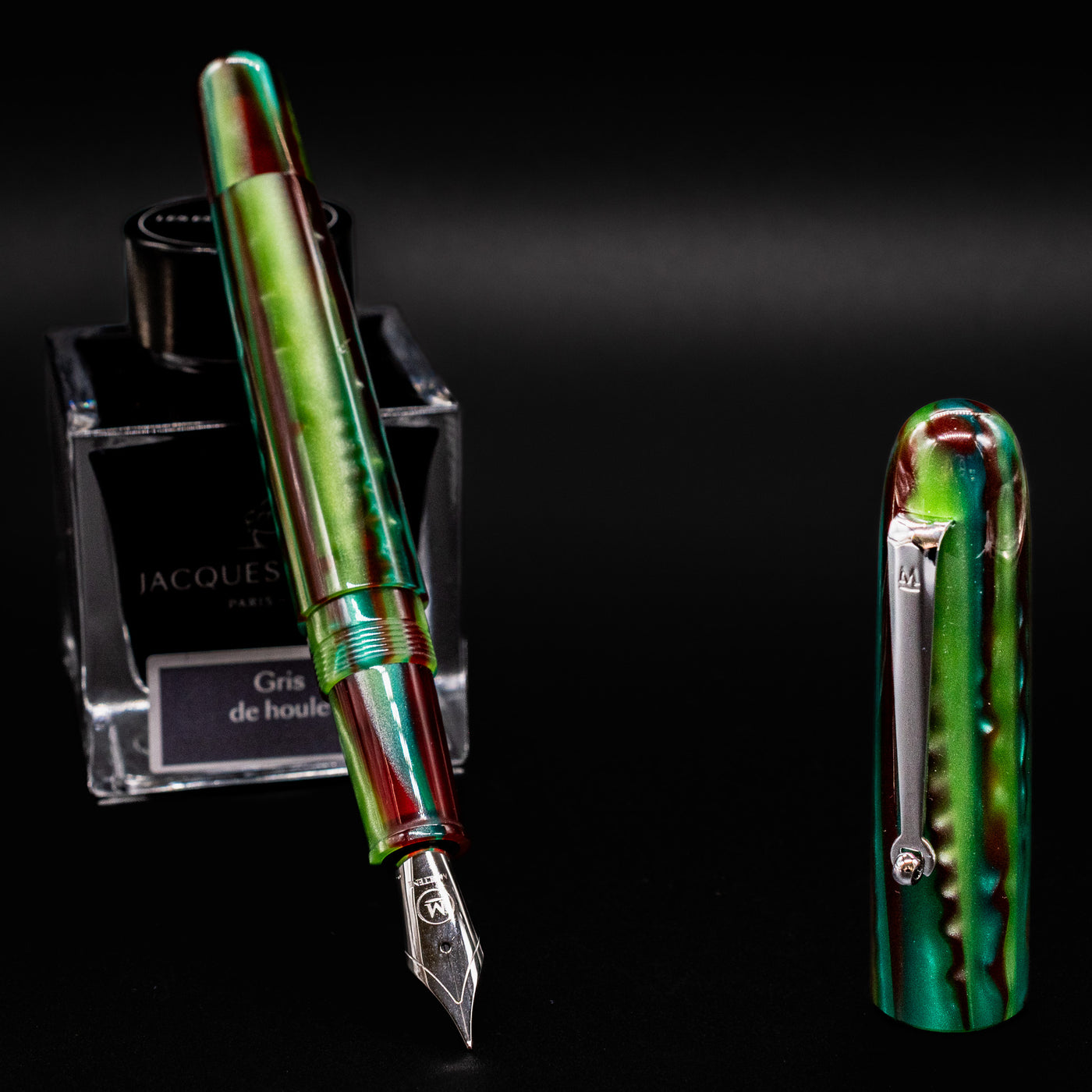 Side view of the Molteni Modelo 71 Fountain Pen in Green and Rhodium with nib exposed and cap standing upright