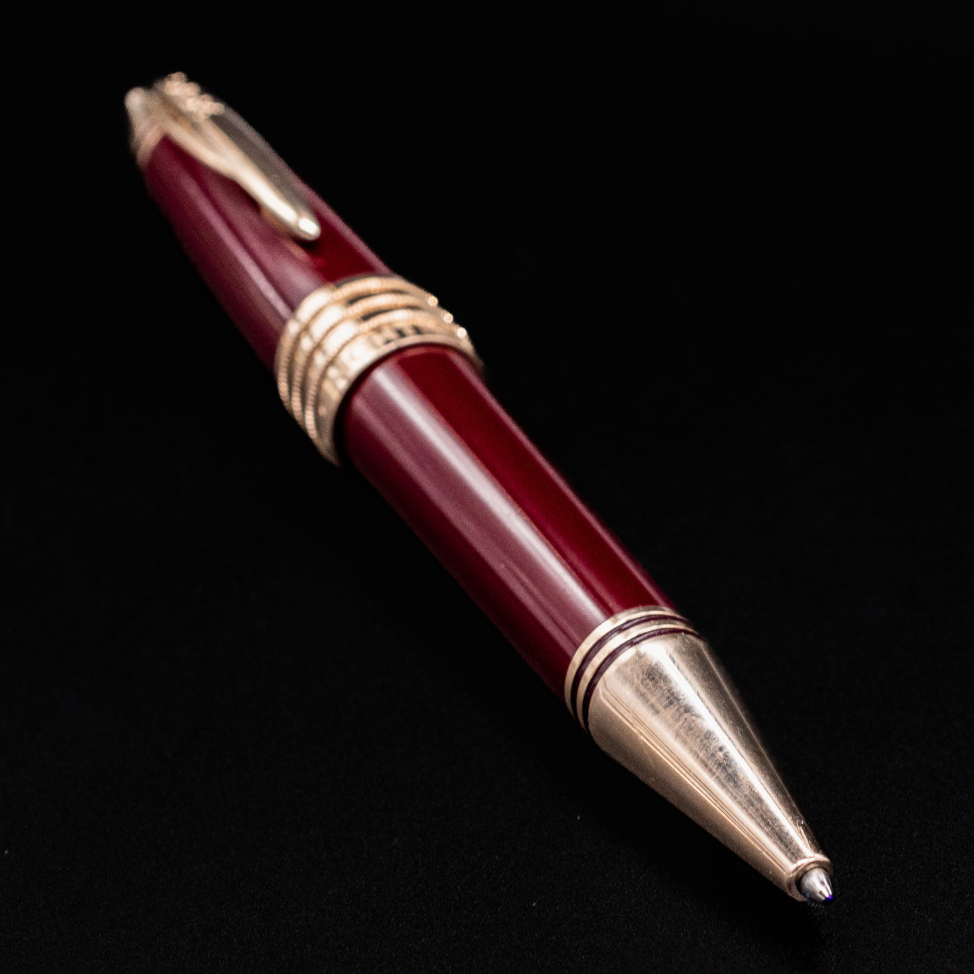 Angled view of the Montblanc JFK Burgundy Ballpoint Pen showing rich burgundy resin and gold trim.
