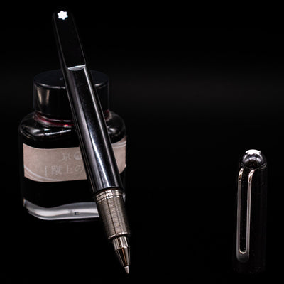 montblanc m by marc newson rollerball with a black background