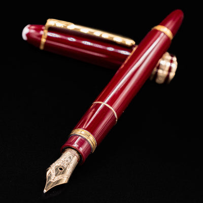 Montblanc Meisterstuck 114R Bordeaux & Gold Mozart Fountain Pen shown uncapped with detailed view of the gold nib – Preowned
