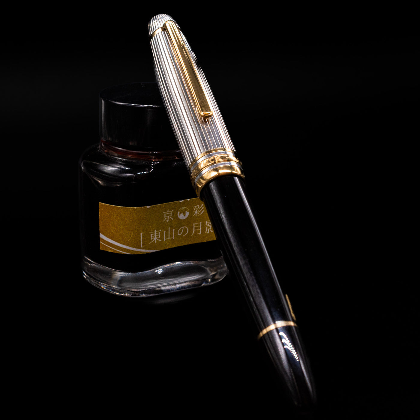 Montblanc Meisterstück 146DS Solitaire Doue LeGrand fountain pen capped and resting upright against yellow-labeled ink bottle