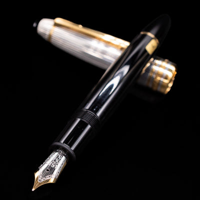 Close-up view of the nib and barrel of the Montblanc Meisterstück 146DS Solitaire Doue LeGrand fountain pen with the cap in background