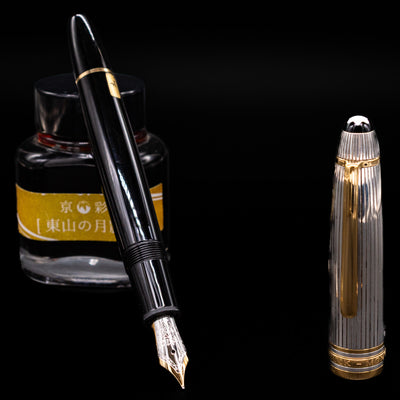 Montblanc Meisterstück 146DS Solitaire Doue LeGrand fountain pen uncapped with nib exposed, shown next to yellow-labeled ink bottle
