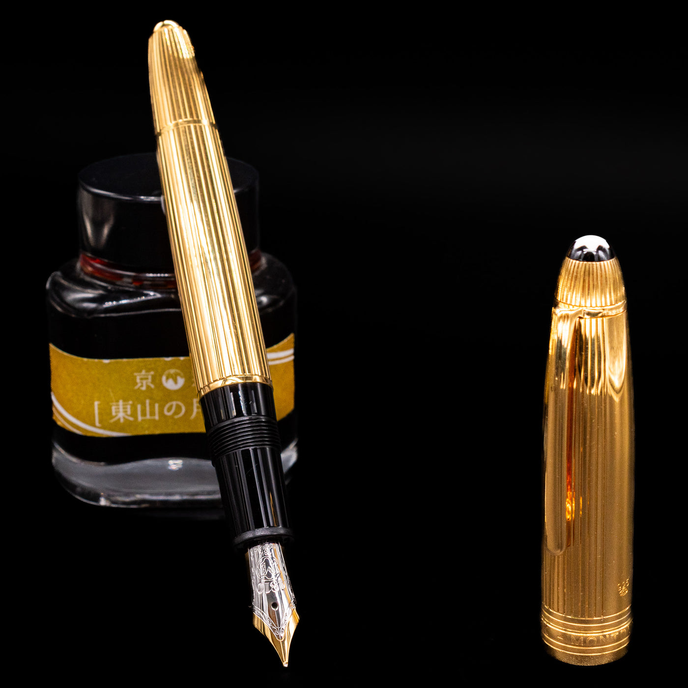 Capped Montblanc Meisterstück 146V Vermeil Pinstripe LeGrand Fountain Pen resting on yellow label ink bottle